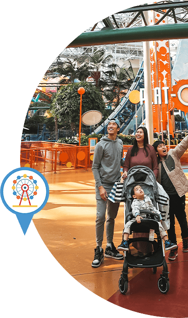 A family walking under the rides in Mall of America.