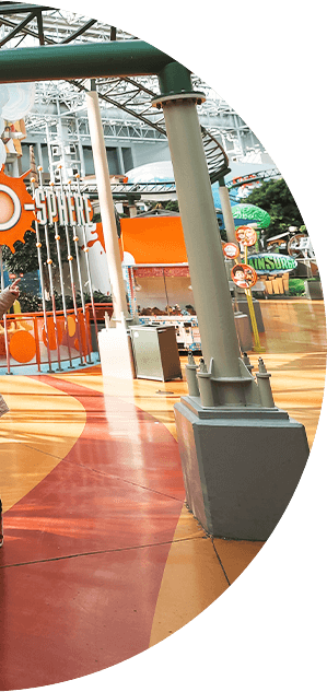 A family walking under the rides in Mall of America.