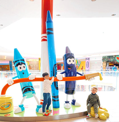 Kids in front of a Crayola exhibit.