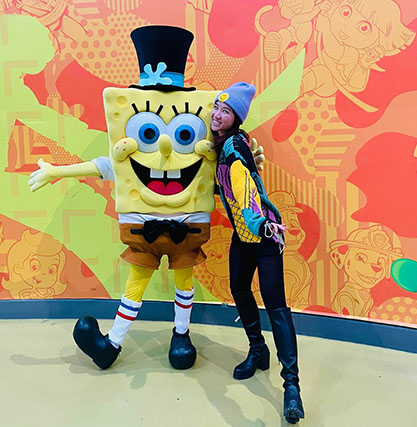A young girl posing with Spongebob at the Mall of America.