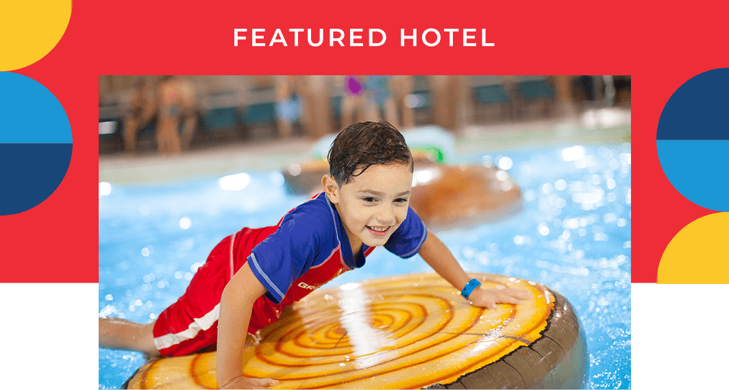 Featured Hotel - A child playing on an inflatable in a pool at the Great Wolf Lodge.